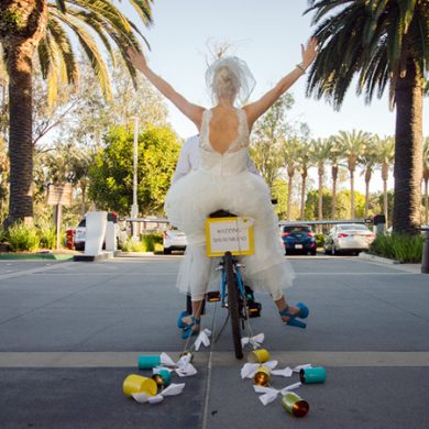 Bride and groom riding off on a motorcycle.
