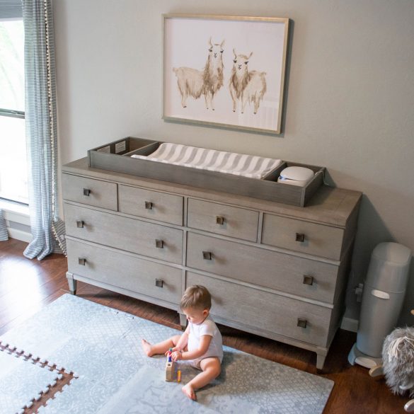 Toddler playing on the Little Nomad playmat in Feather